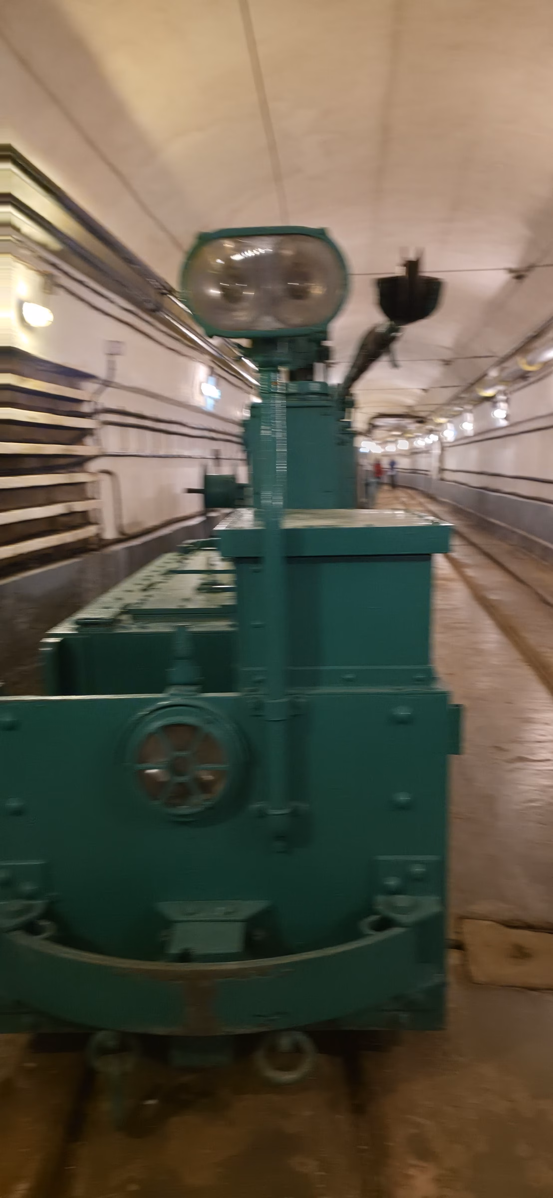 Original electric service train with green-painted body and searchlight in the main underground gallery at Fort Schoenenbourg