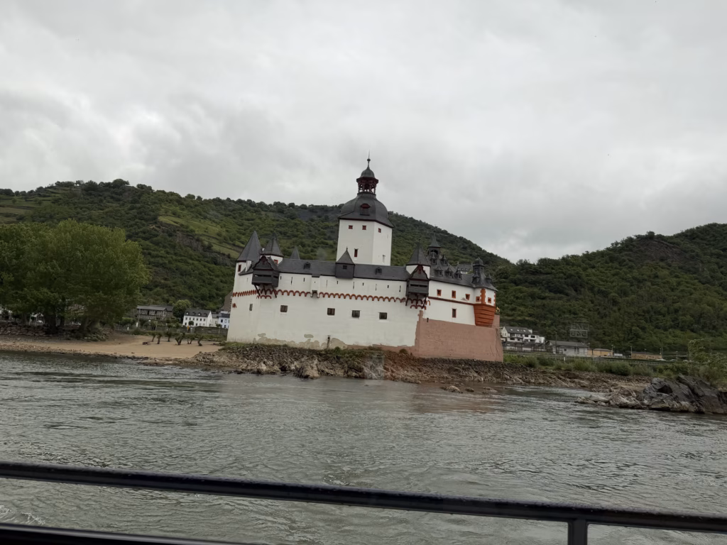 Pfalzgrafenstein, the white toll castle with a tall tower, on its island in the Rhine seen from the boat deck