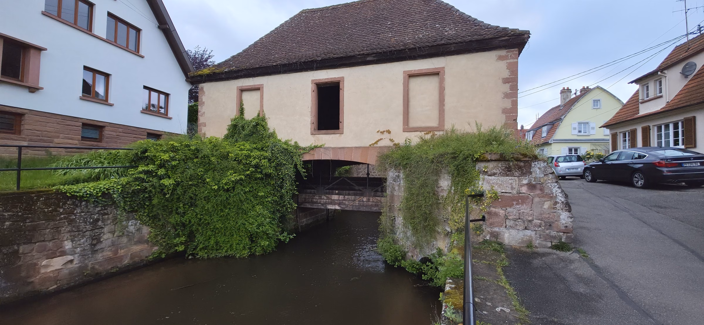 Half-timbered house spanning a small stone bridge over the Lauter canal in Wissembourg