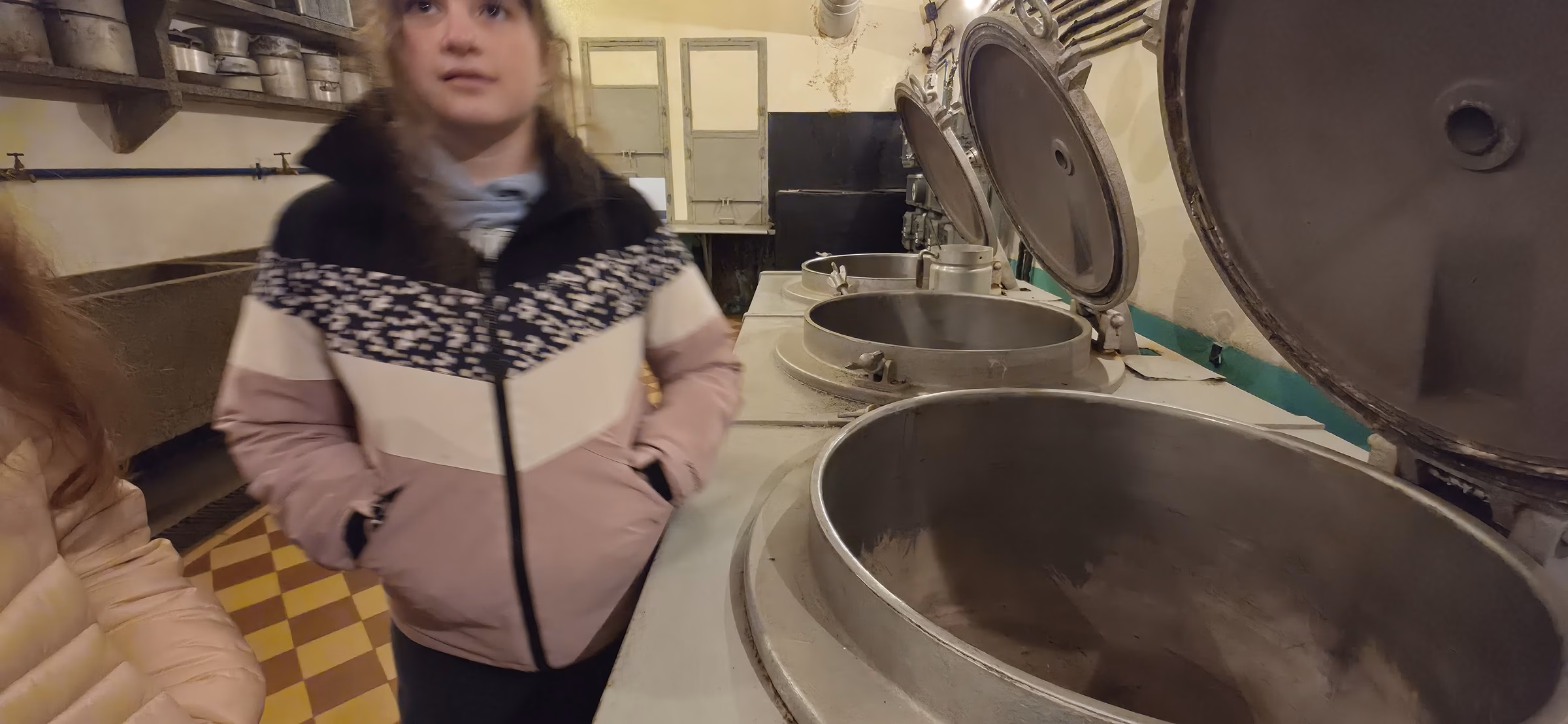 Schoenenbourg kitchen showing a large industrial cauldron with a visitor next to it for scale