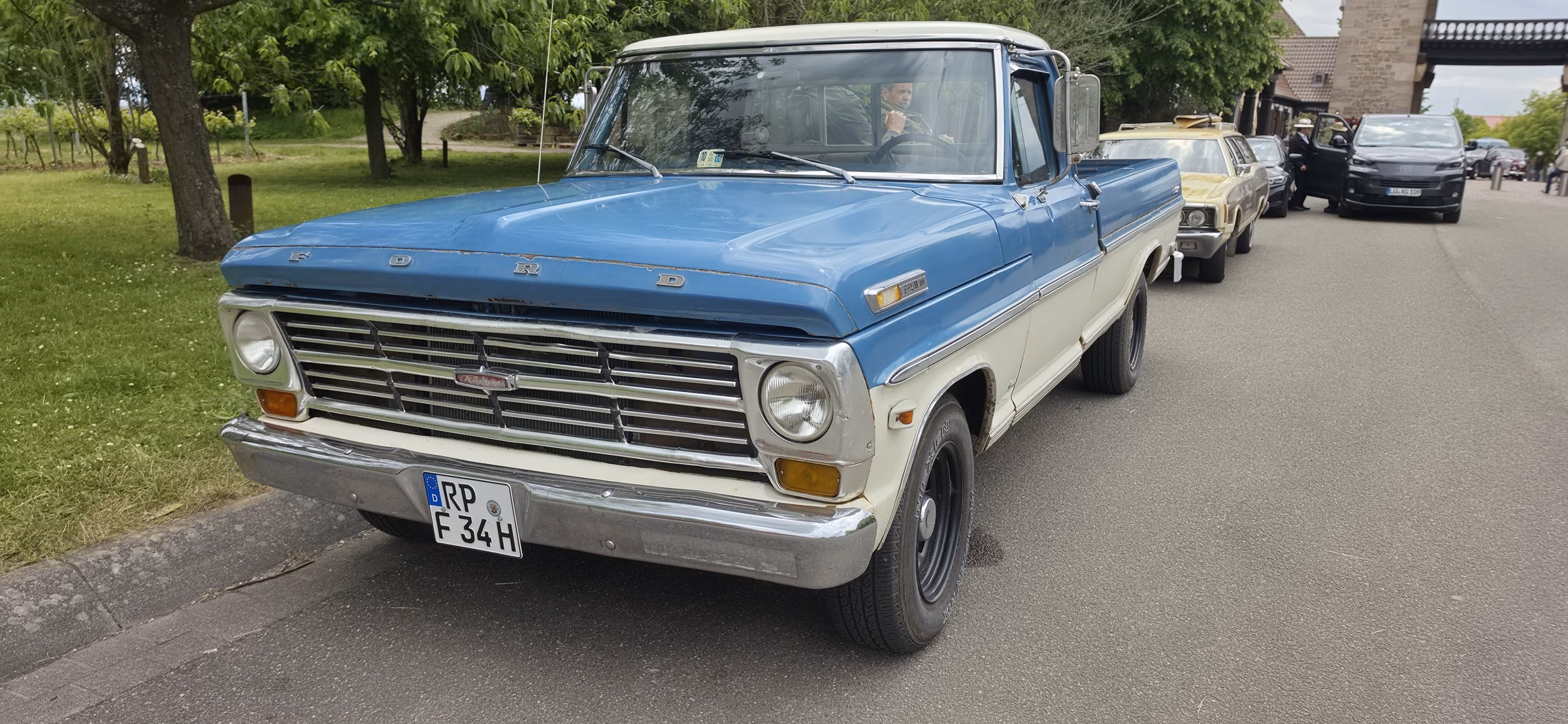 Vintage blue Ford F-series pickup parked at the Deutsches Weintor classic car meet, with a German plate