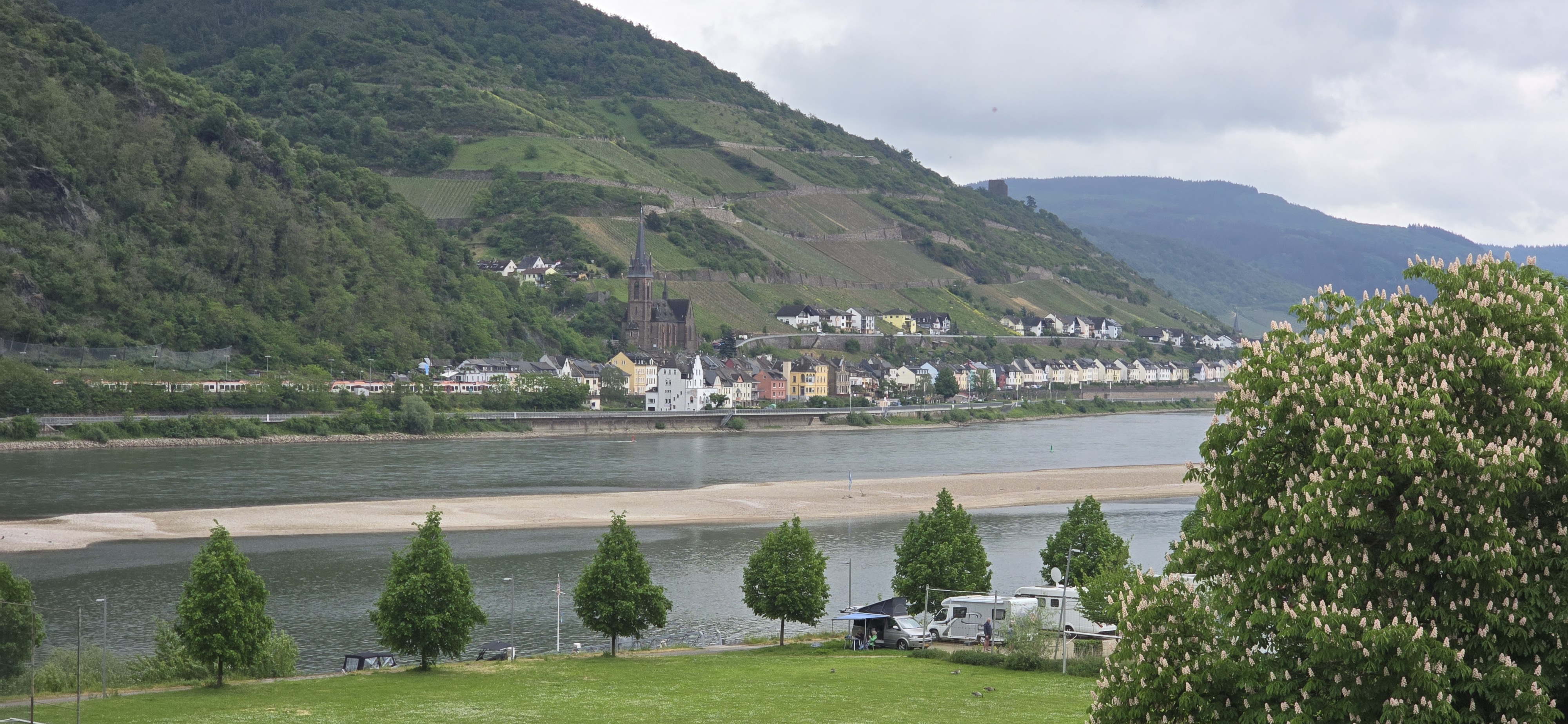 Bacharach train station platform looking south toward the Rhine valley, Oberwesel church tower visible across the river
