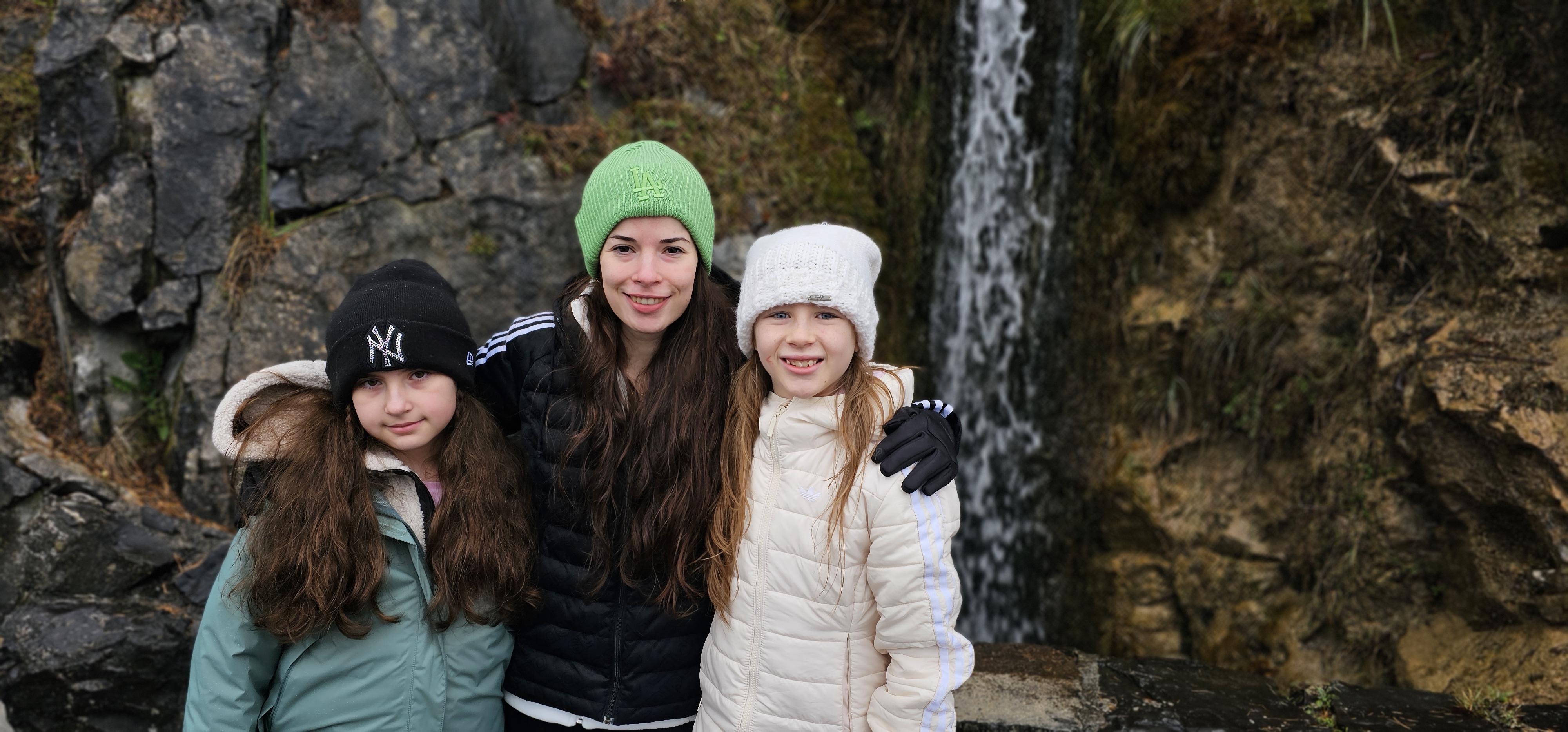 Samira, Lulu, and Sahryah at the cave-entrance waterfall, St. Beatus Caves, December 2023
