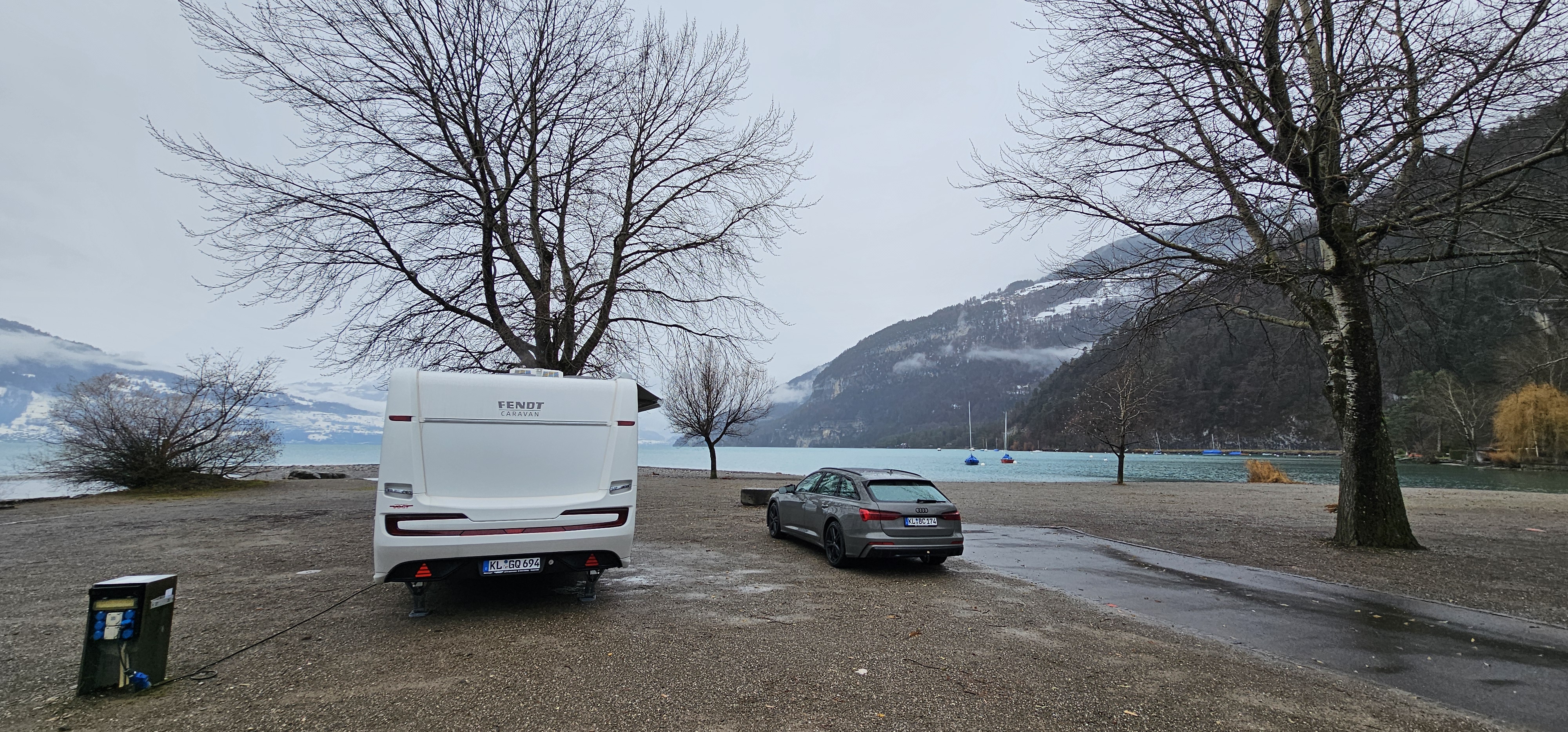 Fendt caravan at the Nublatze pitch, Camping Manor Farm 1, Lake Thun behind under heavy December cloud