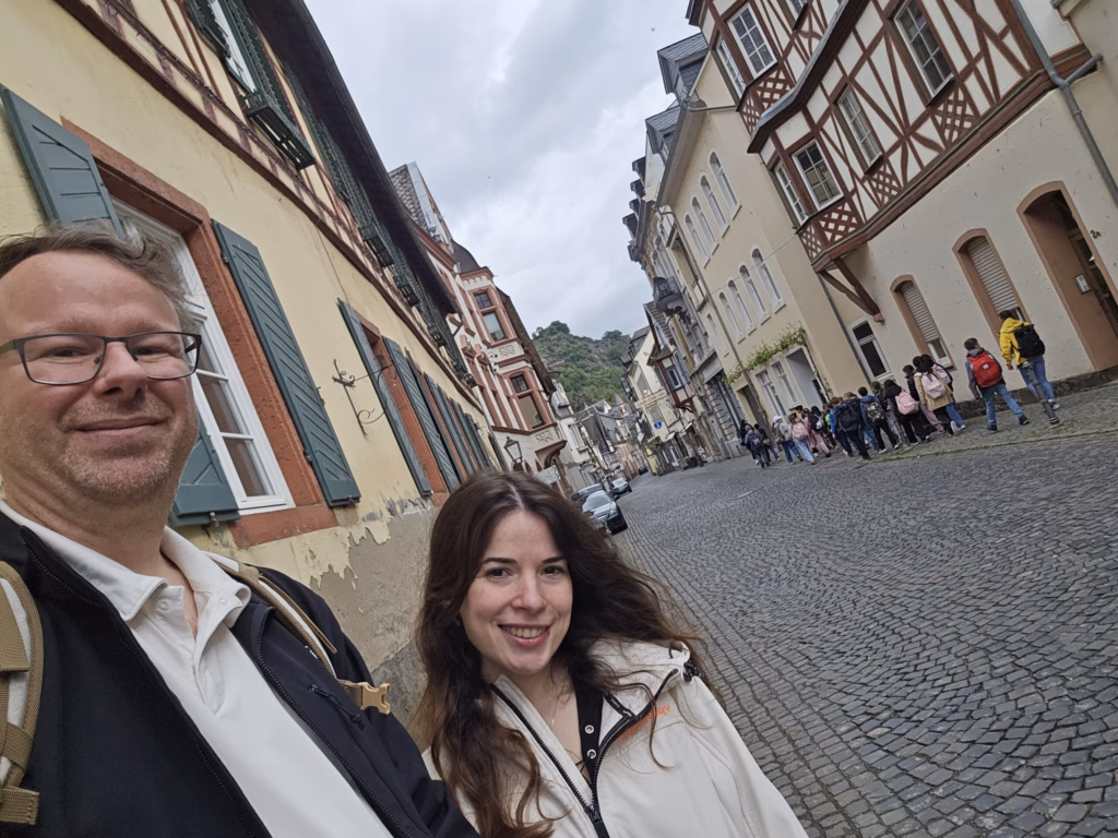 Ryan and Samira taking a selfie in a narrow half-timbered cobbled lane in Bacharach