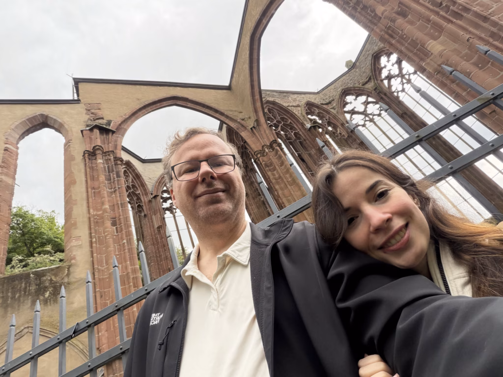 Ryan and Samira taking a selfie at the Werner Chapel ruin with the Gothic arches behind