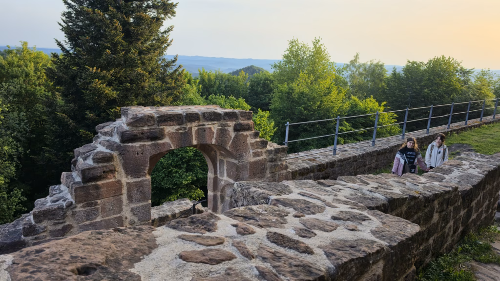 Rock-cut sandstone wall and arched opening of the Wegelnburg ruin along the ridge