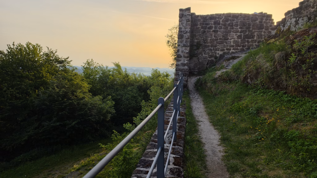 Modern iron handrail running the length of the original sandstone rampart on the eastern wall