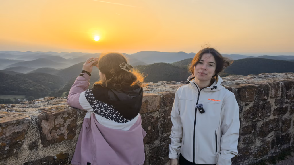 Lulu at the parapet with Samira beside her as the sun clears the cloudbank over the Wasgau