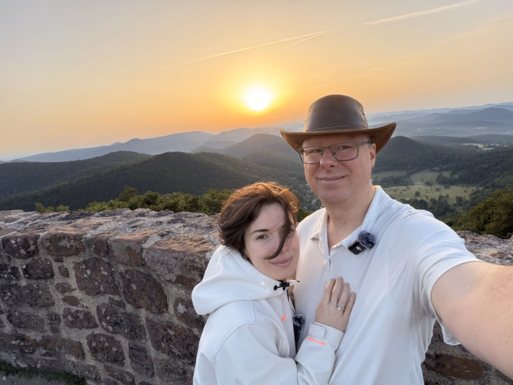 Ryan and Samira at the Wegelnburg wall with the sunrise behind them over the Wasgau